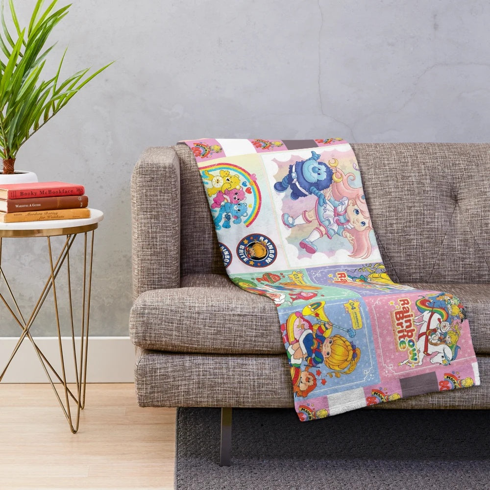 Distressed vintage plush blanket featuring a collage of retro Rainbow Brite and Strawberry Shortcake characters