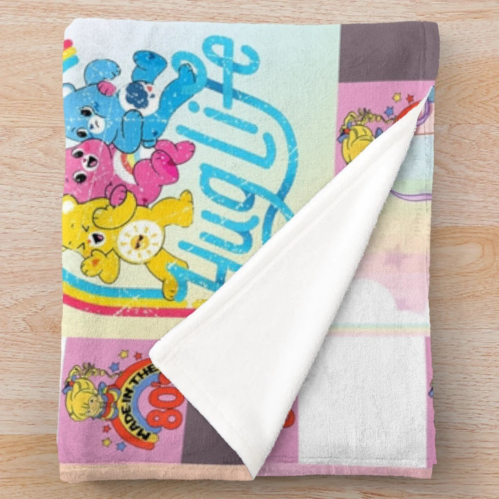 Distressed vintage plush blanket featuring a collage of retro Rainbow Brite and Strawberry Shortcake characters