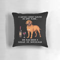 Dogue Bordeaux dog sitting with a glass of wine on a decorative throw pillow
