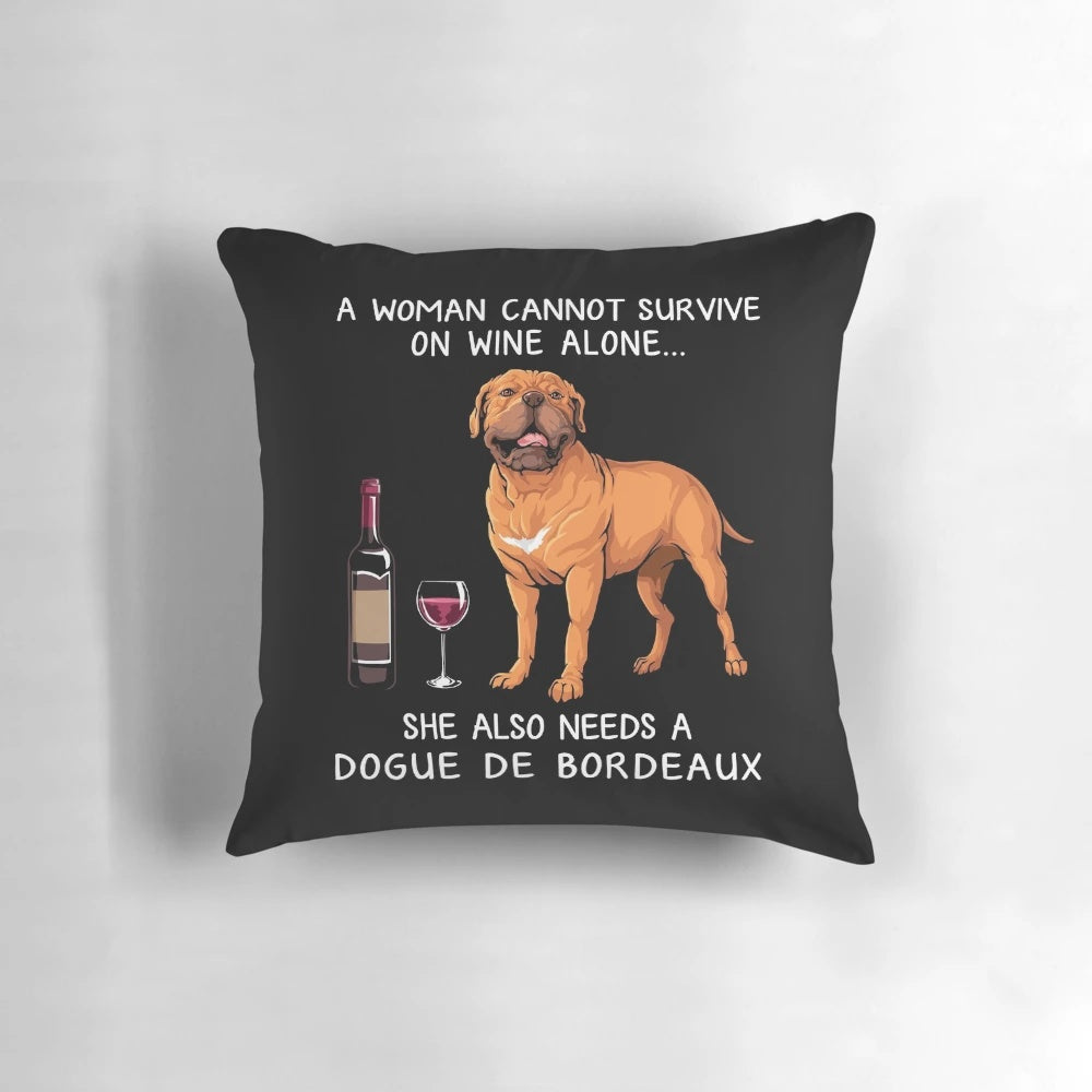 Dogue Bordeaux dog sitting with a glass of wine on a decorative throw pillow