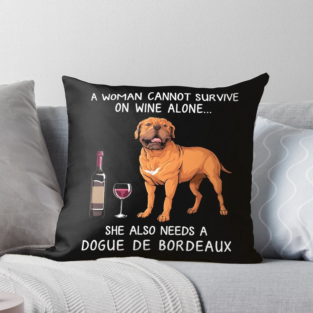 Dogue Bordeaux dog sitting with a glass of wine on a decorative throw pillow