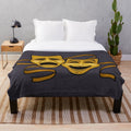 Plush blanket featuring gold comedy and tragedy theater masks