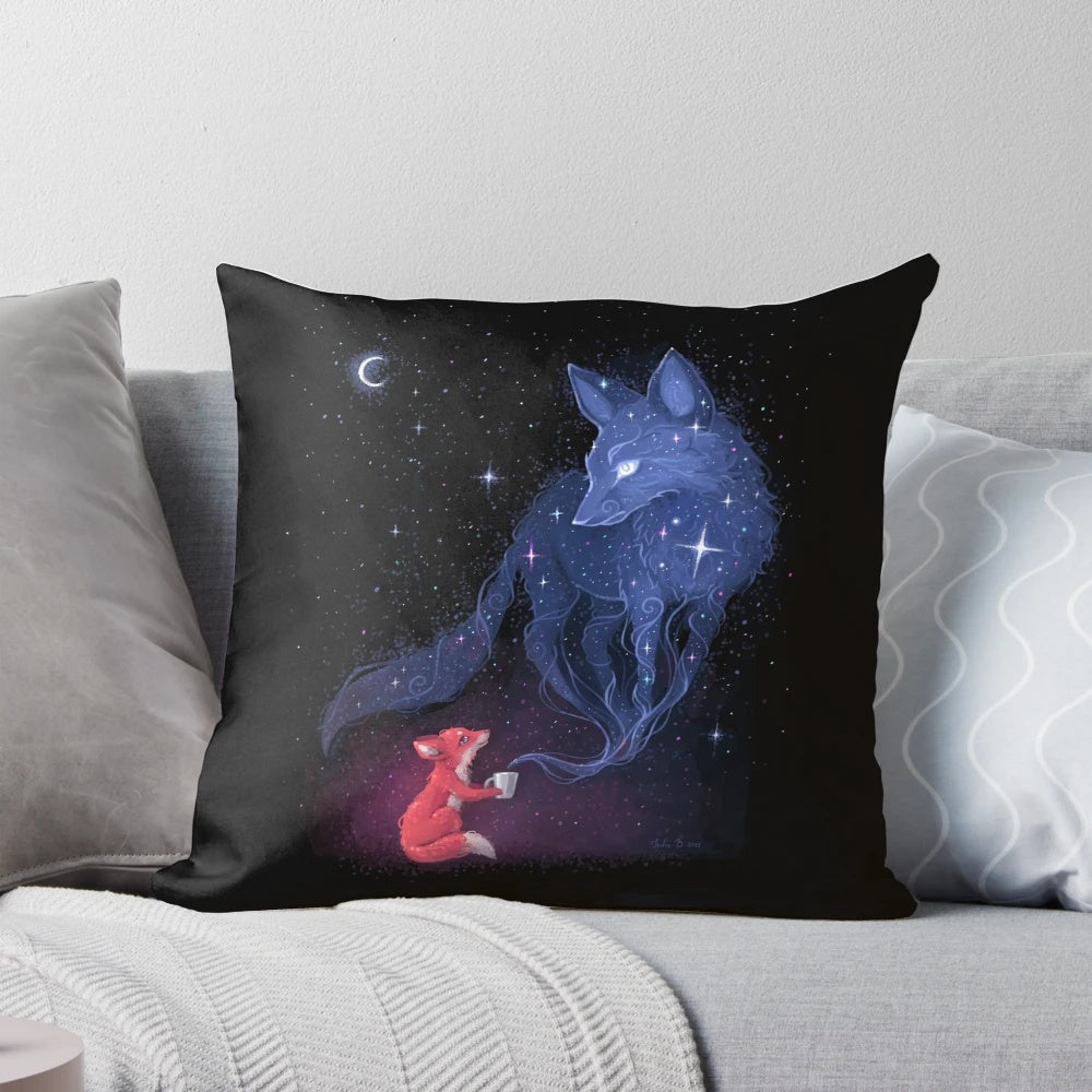 A soft, blue and orange pillow with a celestial design featuring a fox, stars, and the moon.