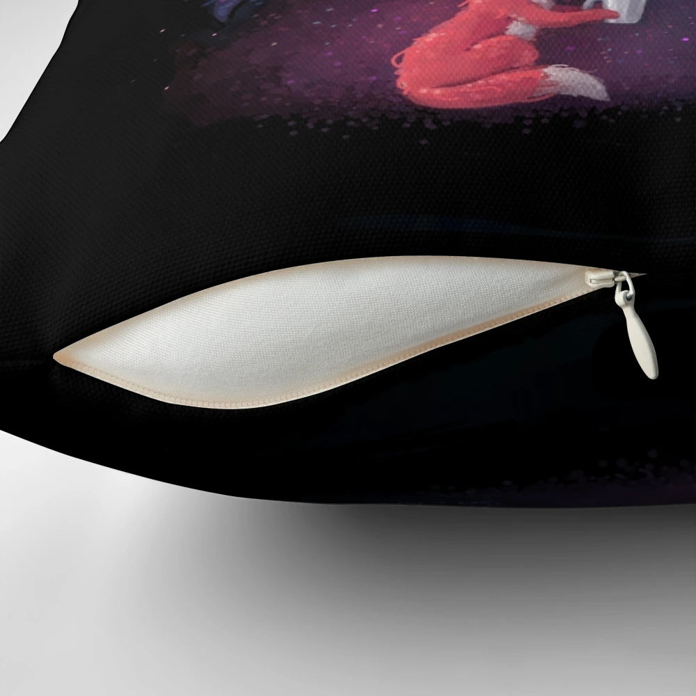 A soft, blue and orange pillow with a celestial design featuring a fox, stars, and the moon.