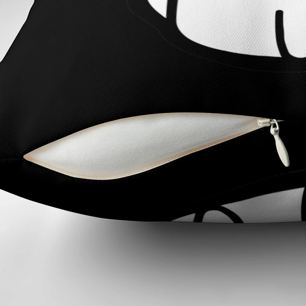 A white and black pillow with a cute cat graphic depicting an explosion or fire, perfect for adding a playful touch to any space.