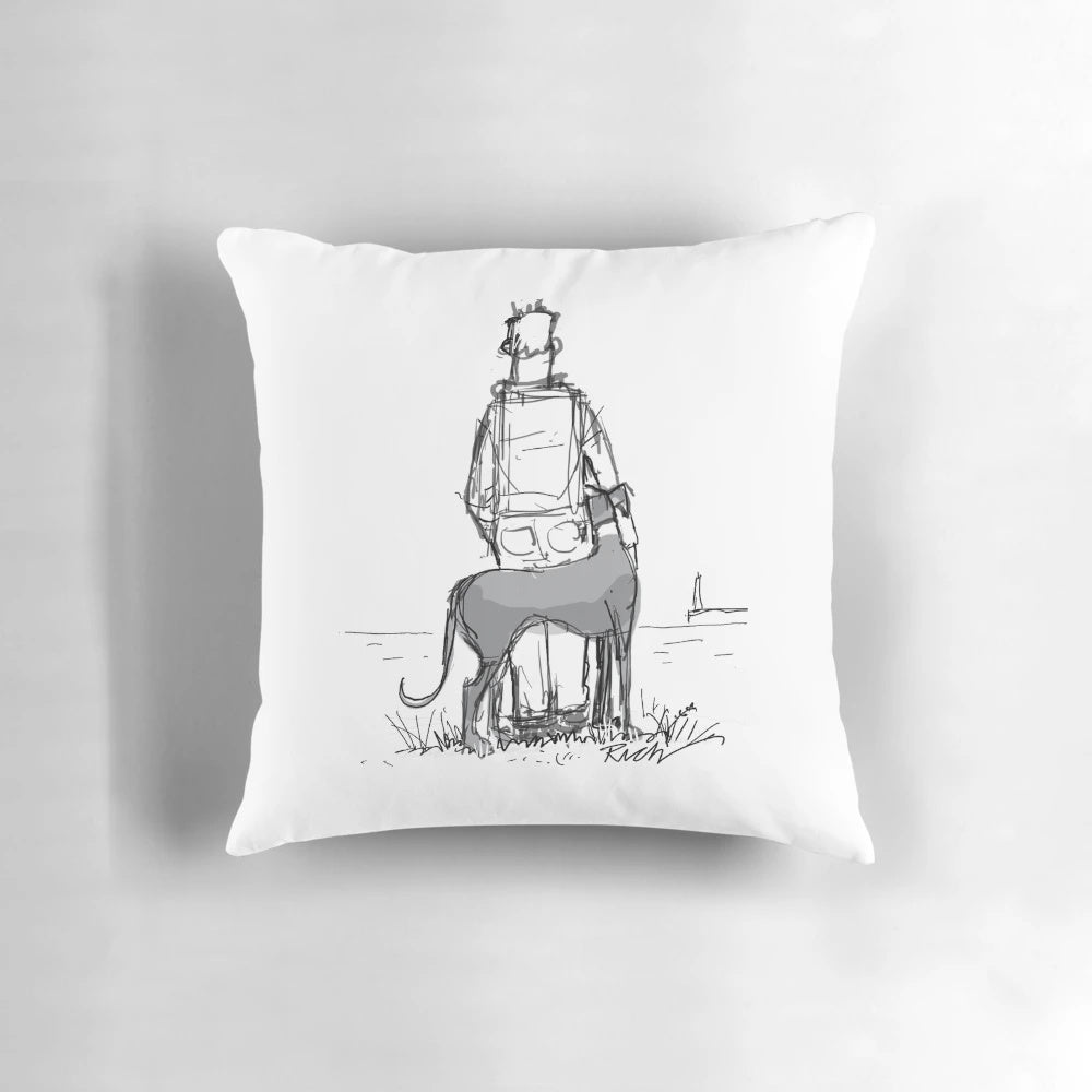 A cozy pillow featuring a greyhound, whippet, or lurcher sighthound dog gazing out at a peaceful coastal seascape.