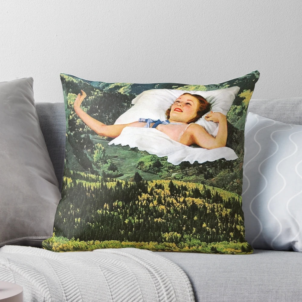 A collage art pillow featuring a surreal, vintage-inspired design of a mountain landscape.