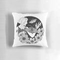 Moody black and white portrait of a woman surrounded by ethereal flowers and butterflies on a decorative pillow