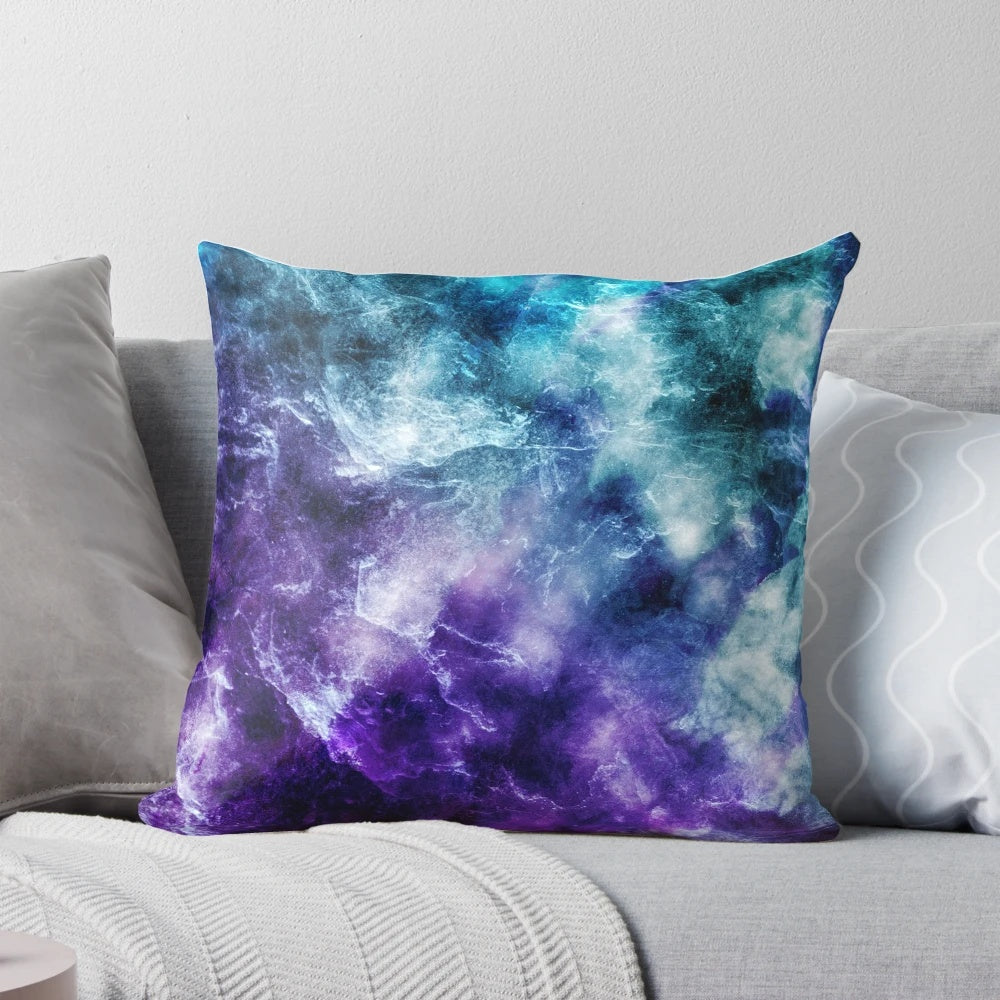 A plush, decorative pillow featuring a captivating galaxy nebula and marble print design in shades of purple and teal.