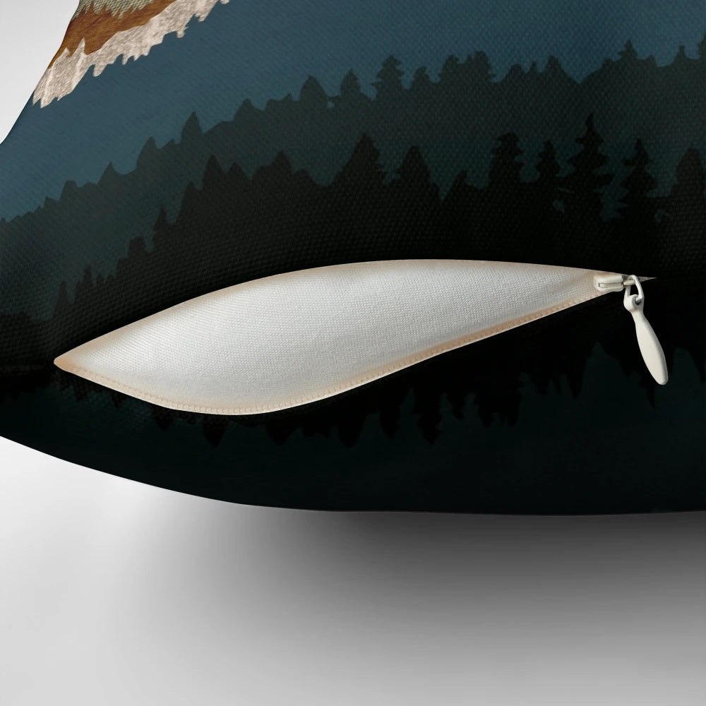 A golden, abstract landscape pillow featuring mountains, trees, and a serene vista.