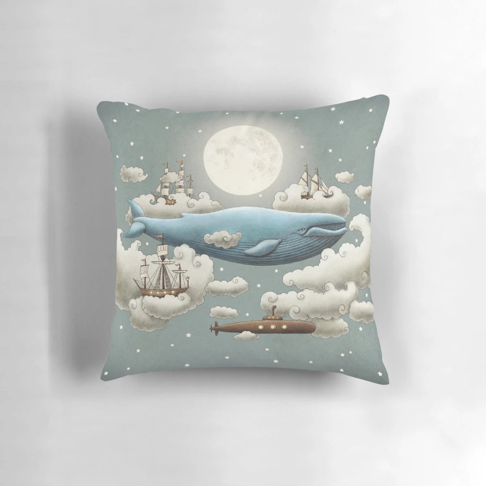 Ocean themed pillow featuring a blue whale, tall ships, and a cloudy sky