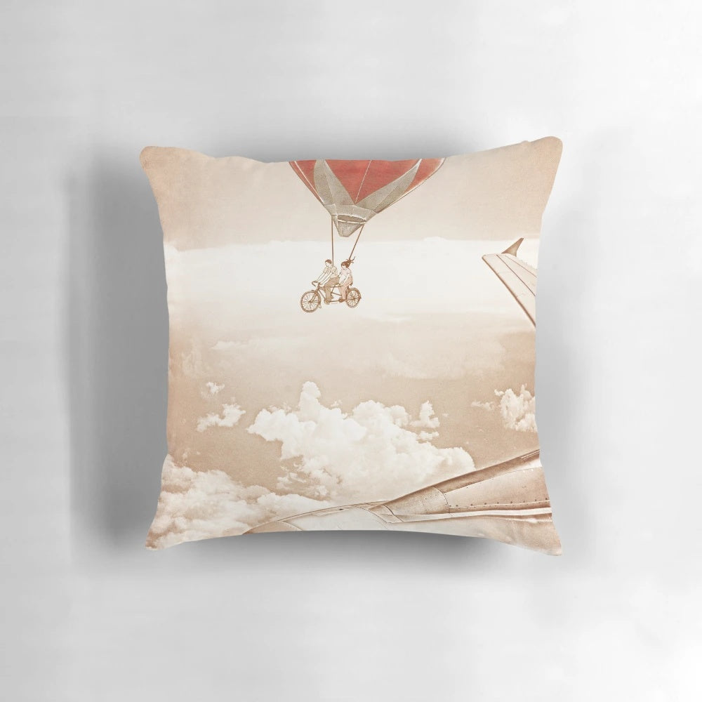 Whimsical vintage-inspired pillow design featuring a couple riding a tandem bicycle among clouds and hot air balloons, with a focus on the "Wednesday Dream" theme.