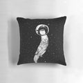Colorful pillow featuring a drifting otter in a starry outer space scene