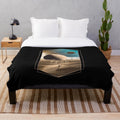Dune-inspired plush blanket with Muad'Dib symbol on Arrakis desert