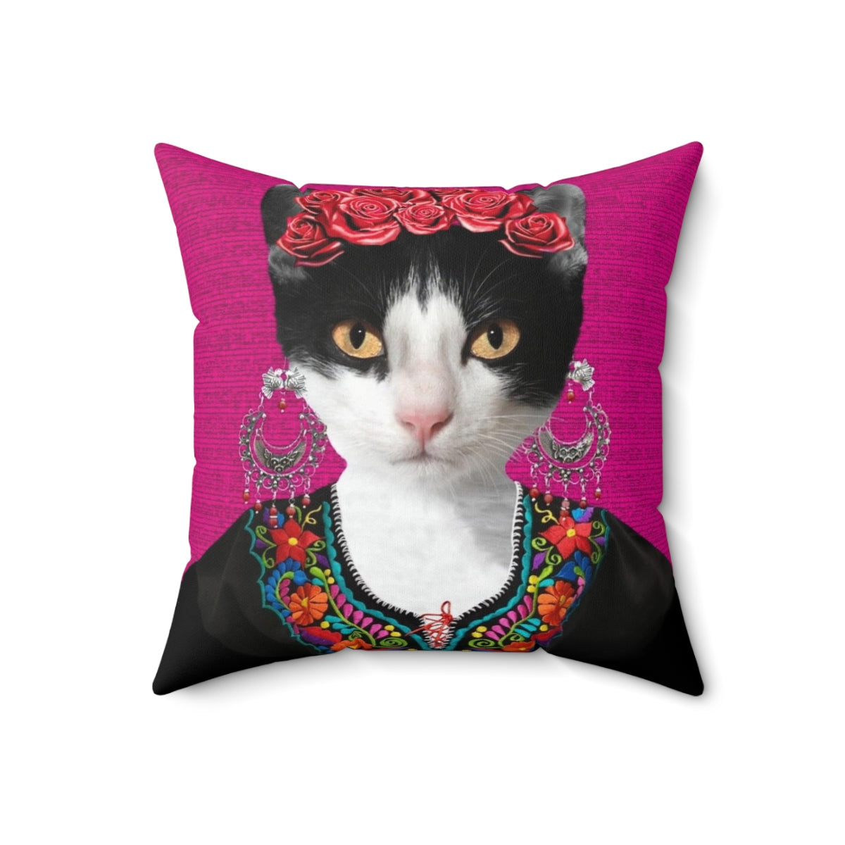 A pink and floral decorative pillow featuring a playful black cat, inspired by the iconic artwork of Mexican artist Frida Kahlo.