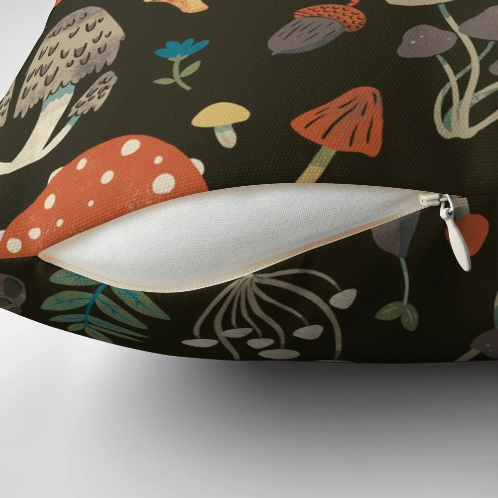 A cozy forest-inspired pillow featuring a repeating mushroom and leaf pattern in shades of brown and green.