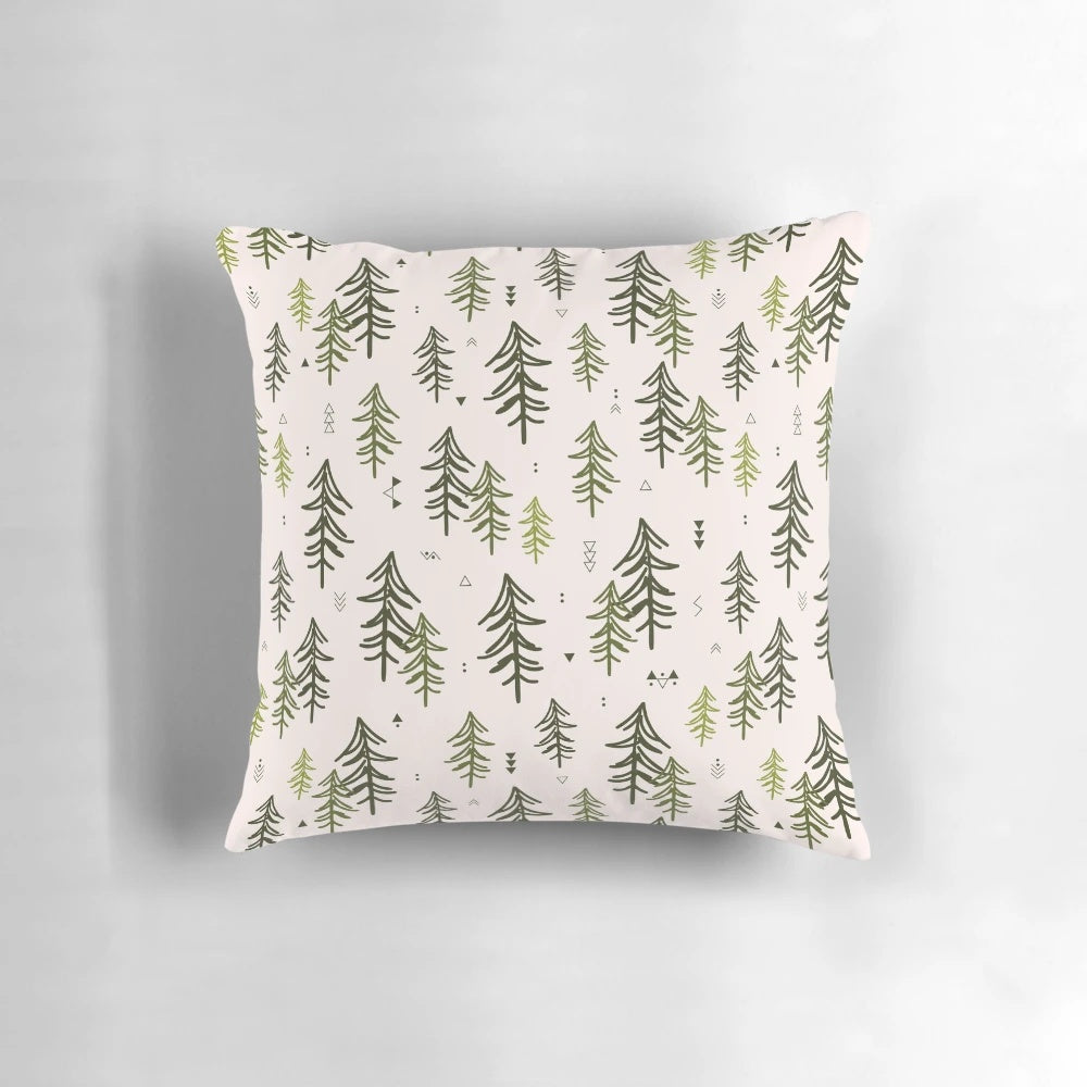 A decorative throw pillow featuring a hand-drawn pattern of stylized fir trees in shades of green.