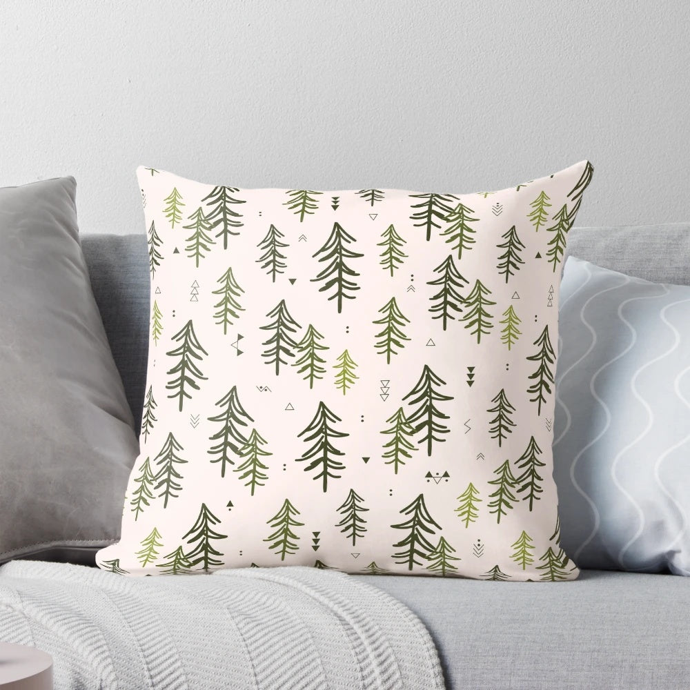 A decorative throw pillow featuring a hand-drawn pattern of stylized fir trees in shades of green.
