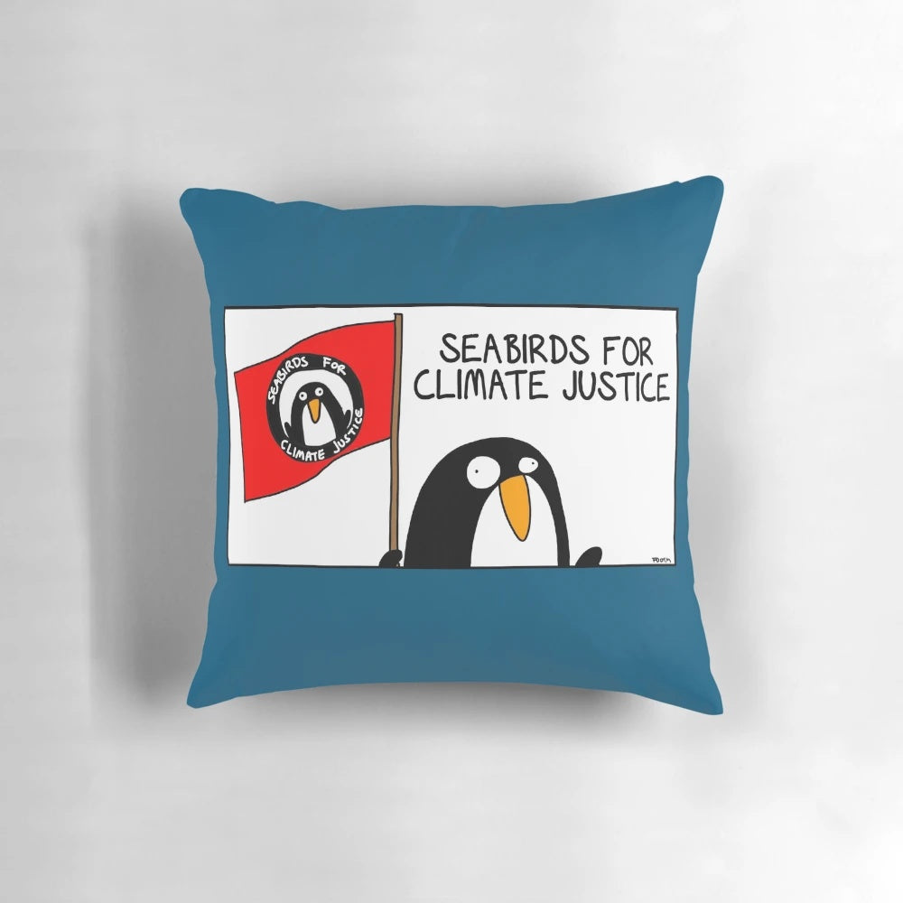 A soft and cozy pillow featuring an illustration of seabirds, promoting climate justice and environmental protection.
