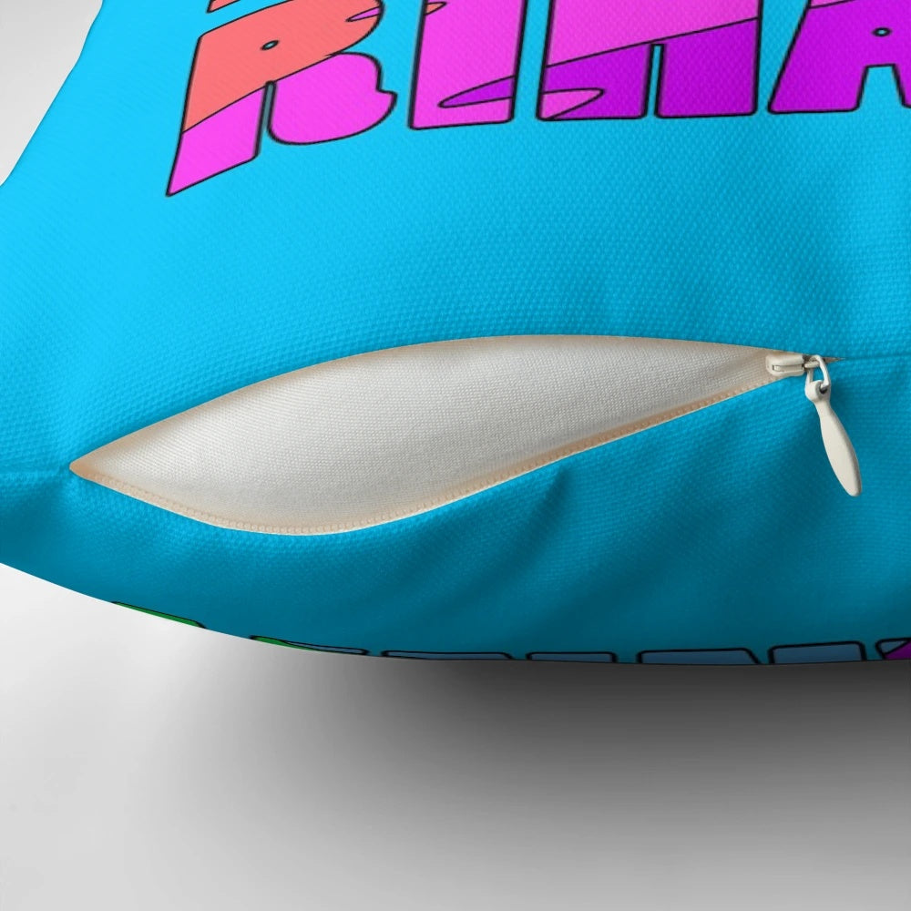 Colorful pillow with the text "The Four R's: Reduce, Reuse, Recycle, Rihanna" in a rainbow design