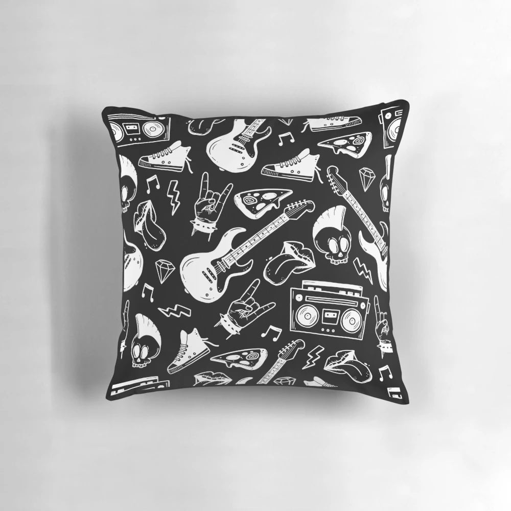 A black and white pillow with an illustrated rock and roll pattern featuring electric guitars, musical notes, and skulls.
