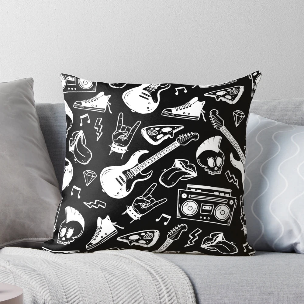 A black and white pillow with an illustrated rock and roll pattern featuring electric guitars, musical notes, and skulls.