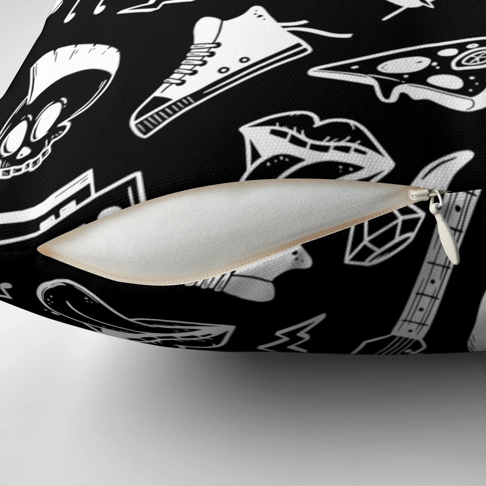 A black and white pillow with an illustrated rock and roll pattern featuring electric guitars, musical notes, and skulls.