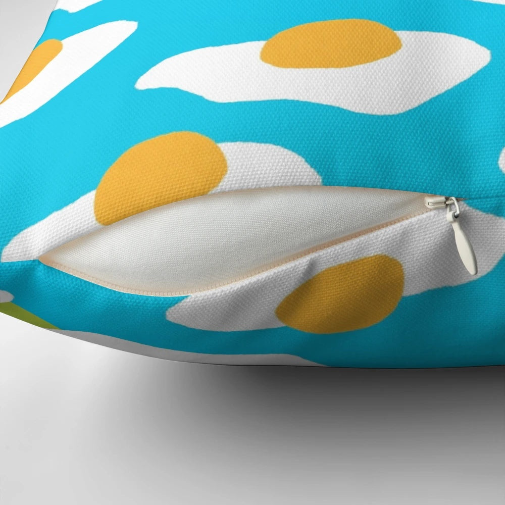 Colorful Eggsellent-themed pillow with a sunny side up egg pattern in blue and green hues