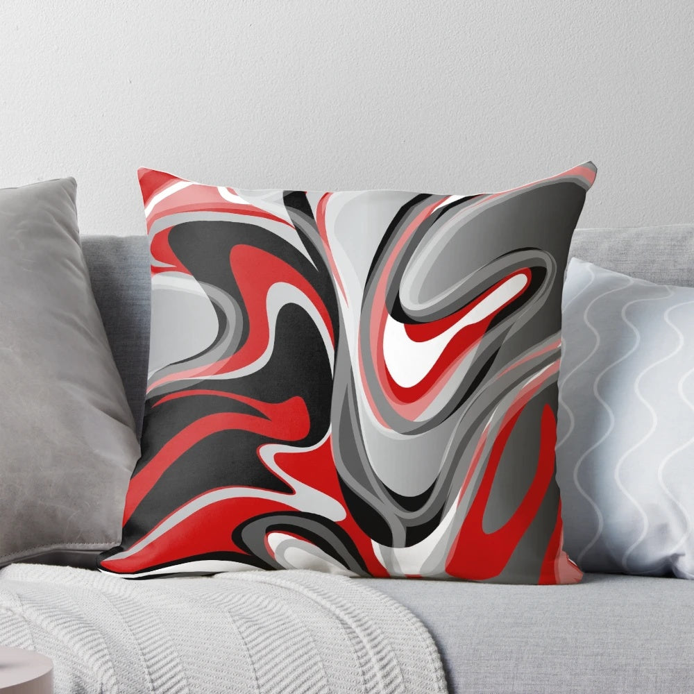 Decorative throw pillow with abstract, marbled red, gray, black, and white fluid design