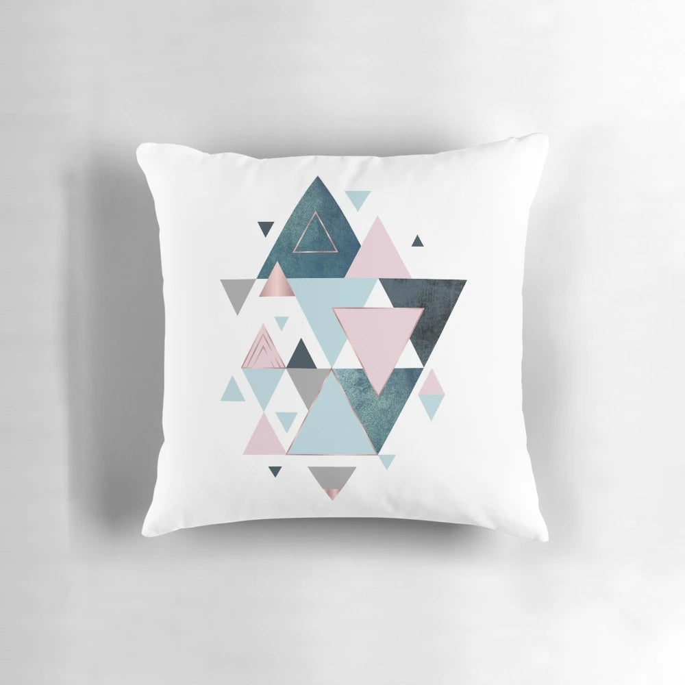 Stylish abstract triangle pattern pillow in shades of pink, teal, and blue