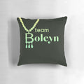 Plush green pillow with embroidered Anne Boleyn Six Wives necklace slogan design