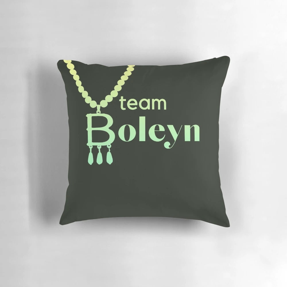 Plush green pillow with embroidered Anne Boleyn Six Wives necklace slogan design