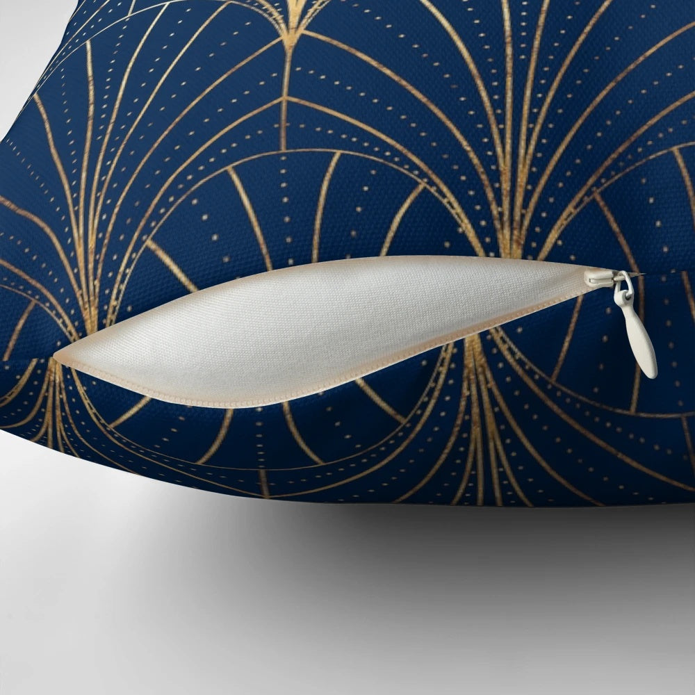 A navy blue decorative pillow with an art deco waterfall pattern in gold and dark colors