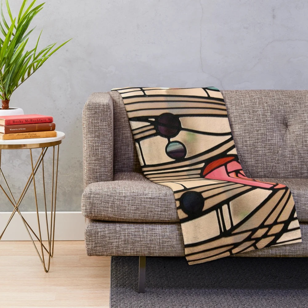 A plush blanket featuring the iconic Mackintosh rose design, inspired by the art nouveau style of Charles Rennie Mackintosh.