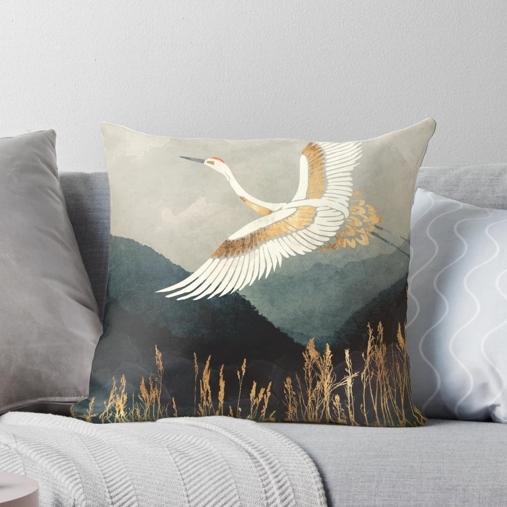 An elegant pillow featuring a watercolor-style design of a flying crane or bird in a nature landscape.