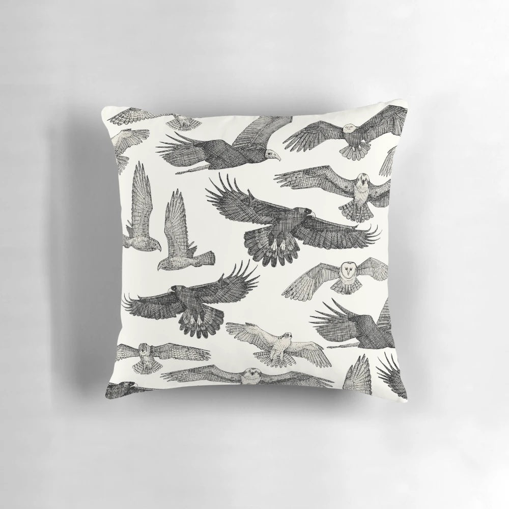 A stylish black throw pillow featuring a stunning pattern of birds of prey like owls, hawks, and eagles.