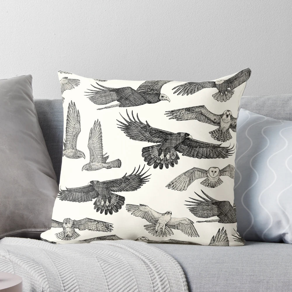 A stylish black throw pillow featuring a stunning pattern of birds of prey like owls, hawks, and eagles.