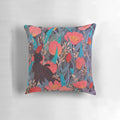 Illustration of a black cat surrounded by red tulip flowers on a decorative throw pillow