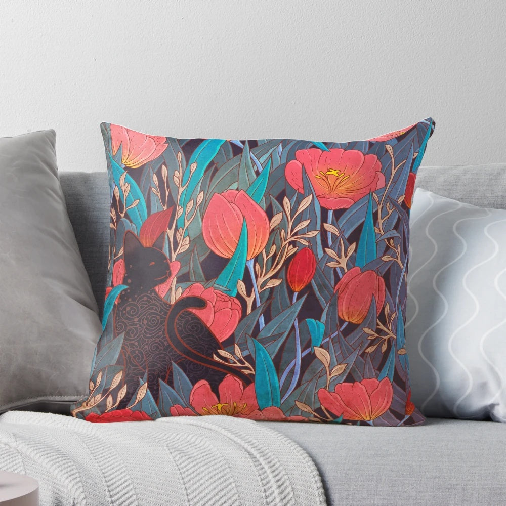 Illustration of a black cat surrounded by red tulip flowers on a decorative throw pillow