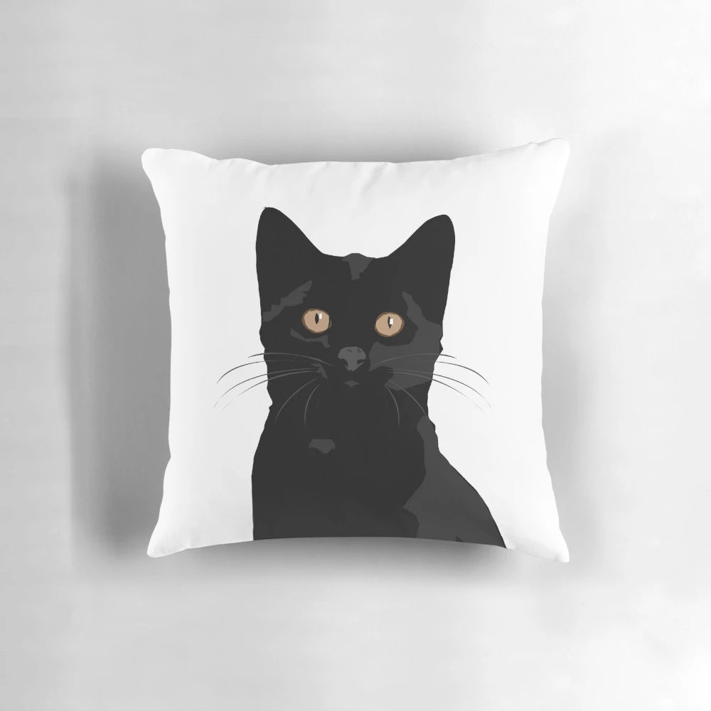 A black cat peeking out from a plush, comfortable pillow