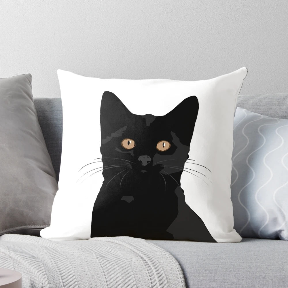 A black cat peeking out from a plush, comfortable pillow