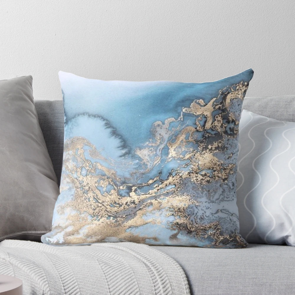 Blue and gold marble decorative pillow with a modern, chic design