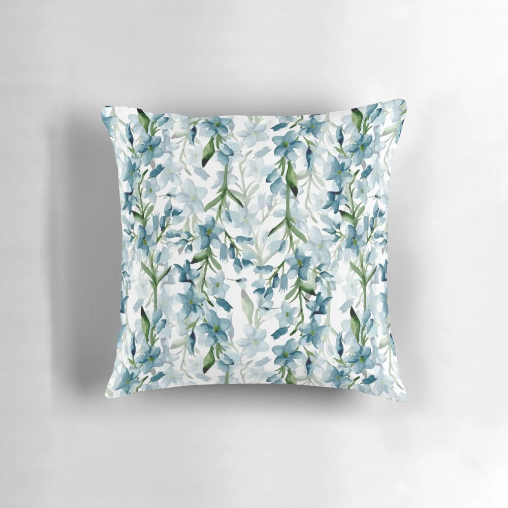 Soft blue watercolor painted branches on a decorative throw pillow