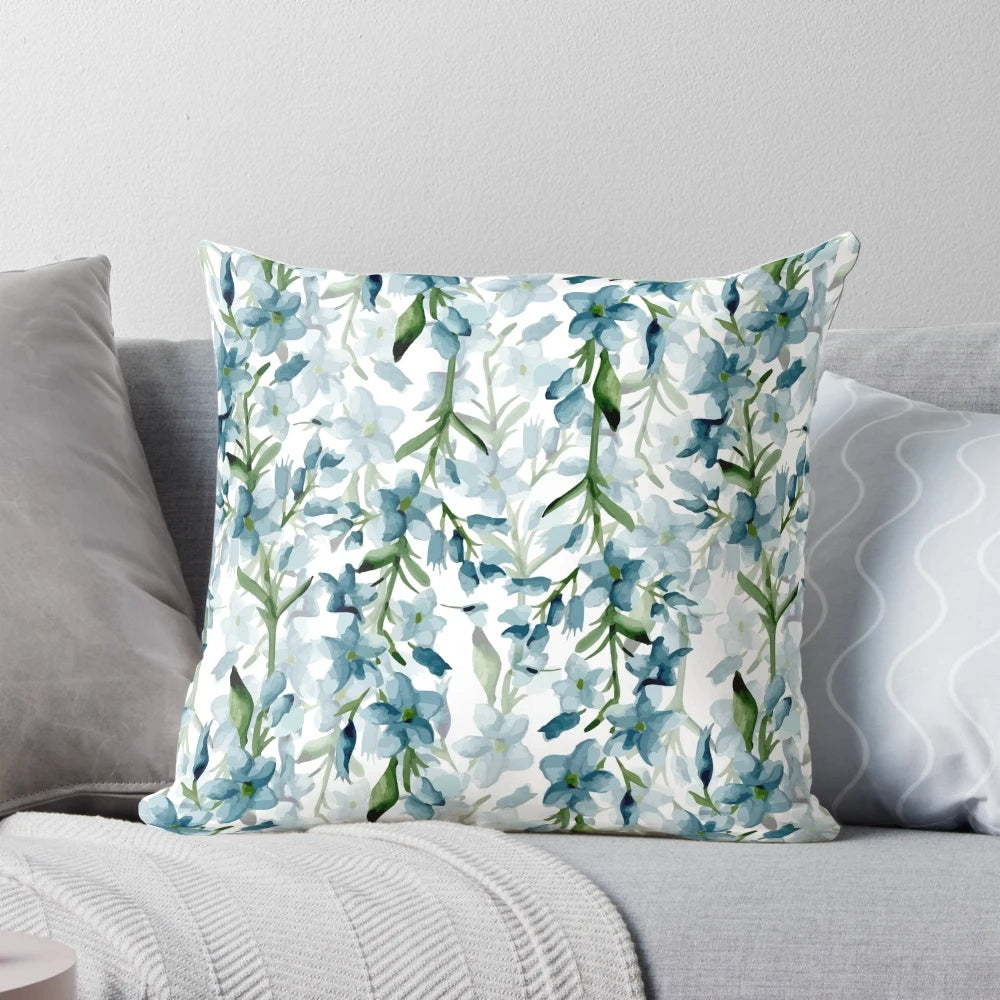 Soft blue watercolor painted branches on a decorative throw pillow