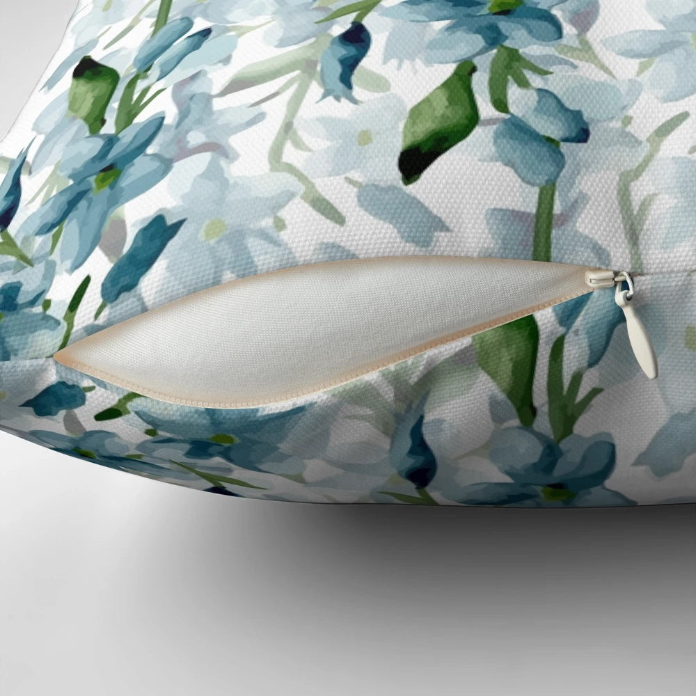 Soft blue watercolor painted branches on a decorative throw pillow