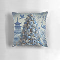 Blue and white chinoiserie-style Christmas pillow with pine branches, berries, and a decorative bow