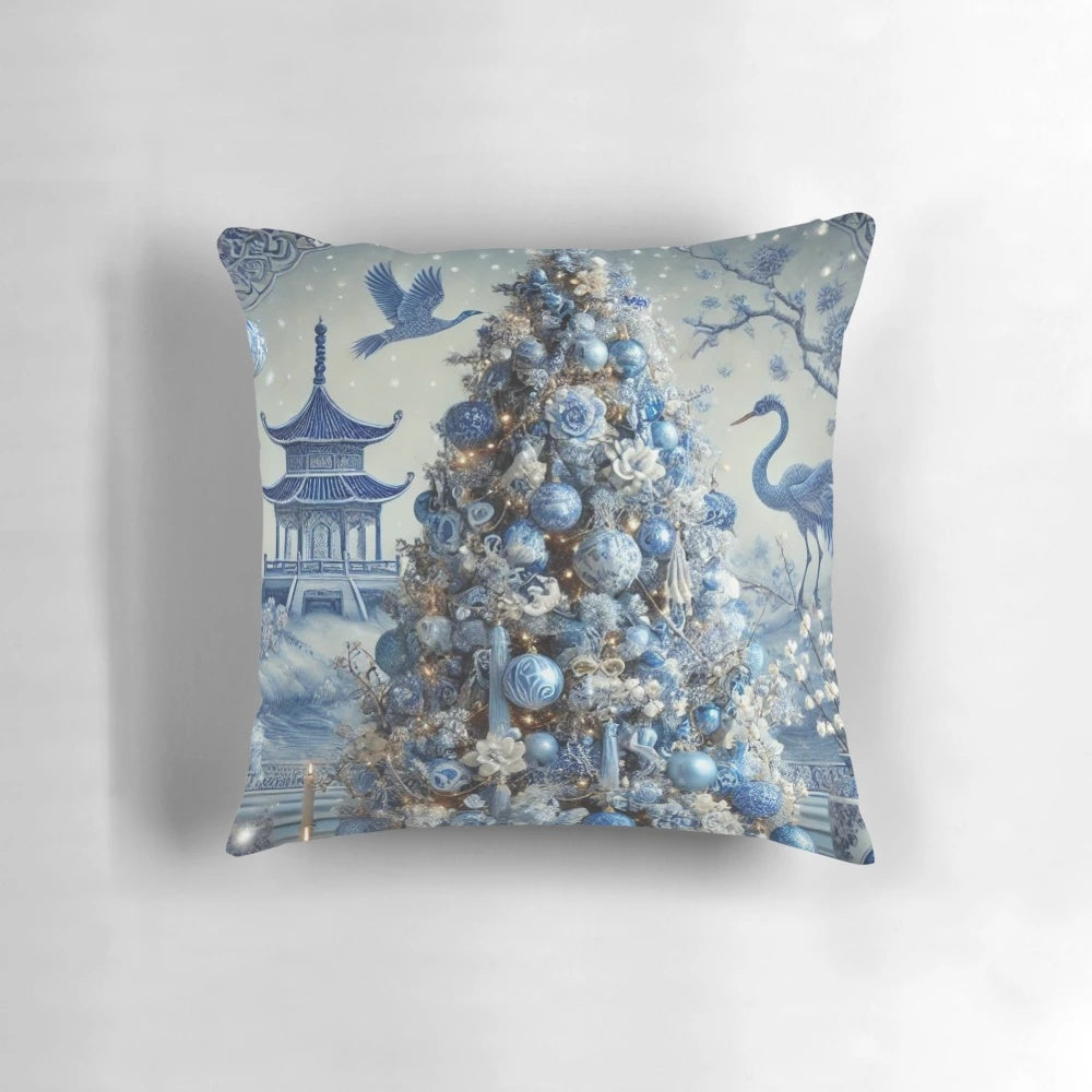Blue and white chinoiserie-style Christmas pillow with pine branches, berries, and a decorative bow