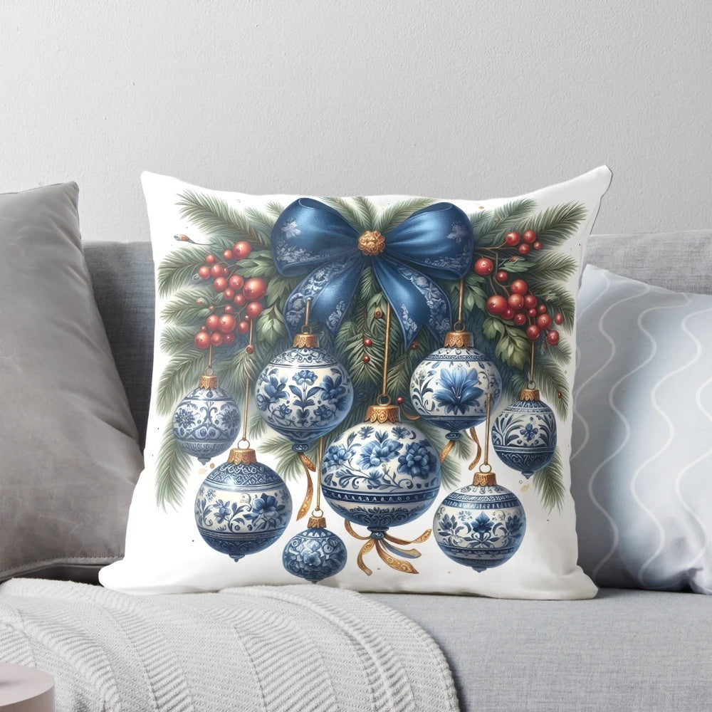 Blue chinoiserie-style Christmas pillow with berries, pine branches, and a bow