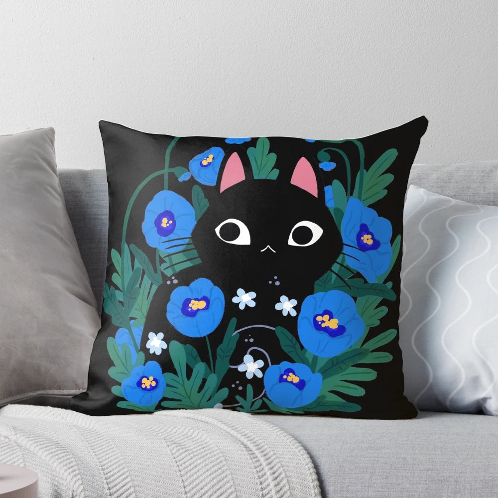 Blue and black throw pillow with an illustration of a black cat surrounded by blue flowers