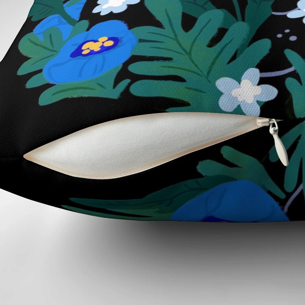 Blue and black throw pillow with an illustration of a black cat surrounded by blue flowers